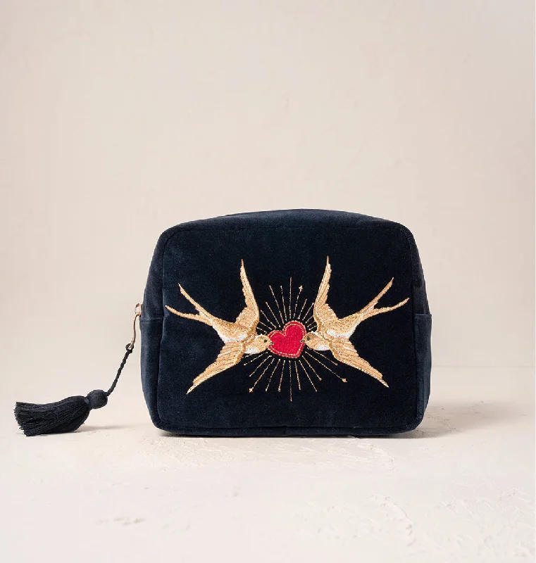 Laser-cut leather makeup bag with an intricate geometric patternSacred Swallows Wash Bag