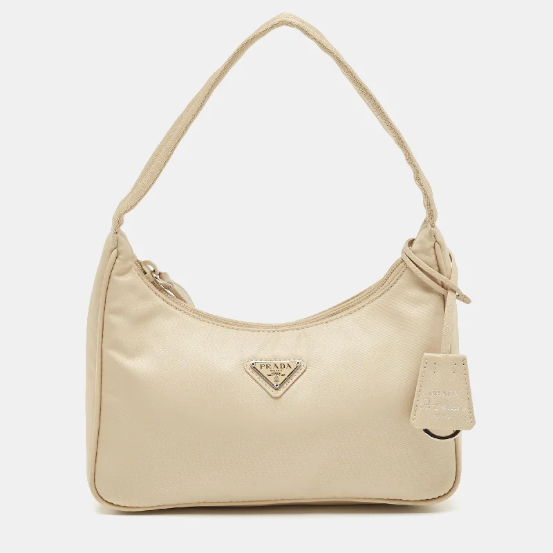 Vintage - inspired hobo bag with a brass frame and tassel detailsPrada Cream Nylon Re-Edition 2000 Bag