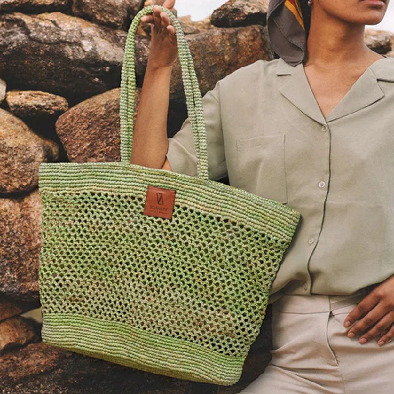 Plus - size bucket bag with a spacious interior for carrying daily essentialsArya Woven Raffia Bucket Bag