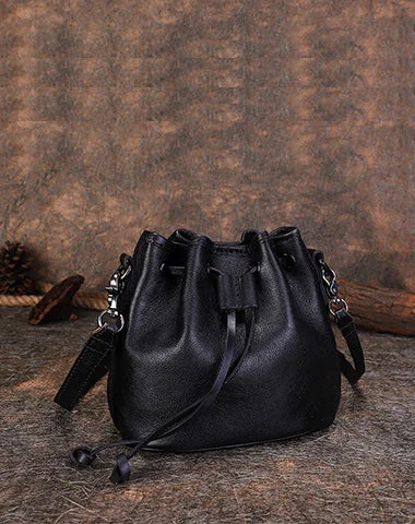 Women's leather crossbody bag with a tassel charm for a bohemian styleWomens Black Leather Barrel Crossbody Bag Purse Vintage Round Bucket Shoulder Bag for Women