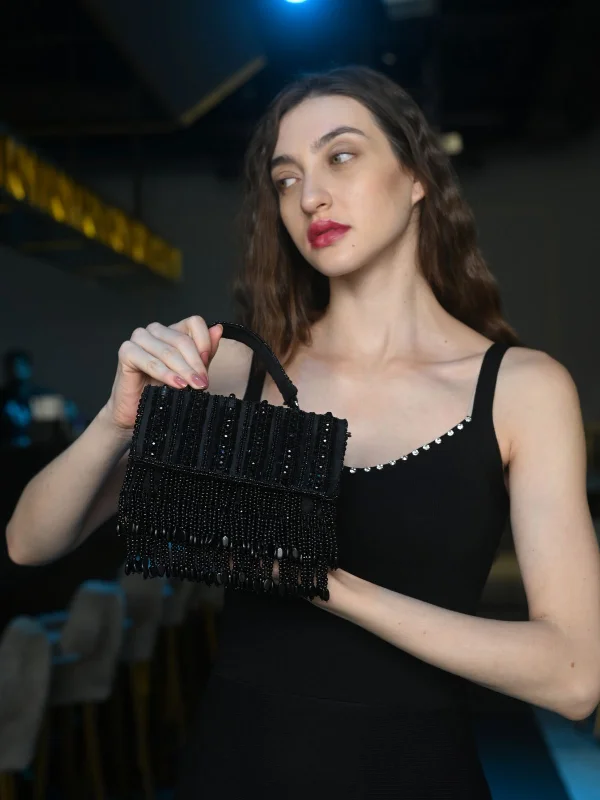 Two - tone clutch with a contrast color lining for added styleOdette Black Embellished Clutch With Tassels For Women