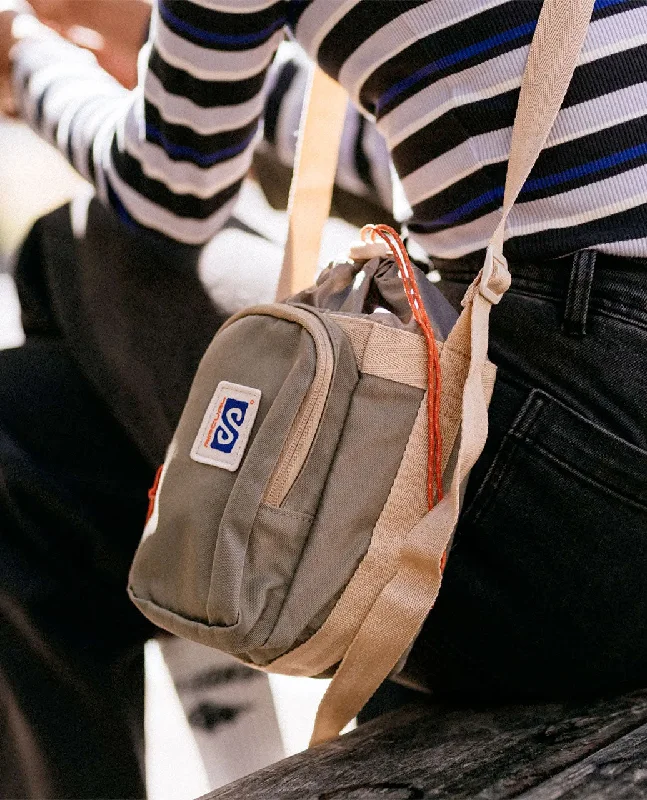 Leatherette backpack with a quilted texture and a magnetic snap closureSearch Bottle Sling Bag - Taupe