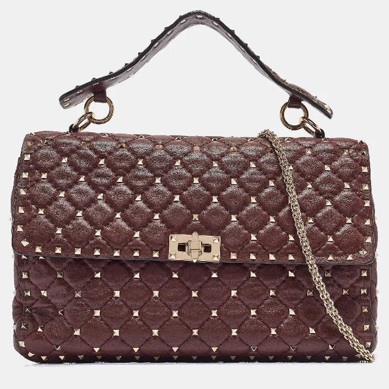 Vintage-inspired satchel with a brass buckle and leather tasselsValentino Burgundy Leather Large Rockstud Spike Top Handle Bag..